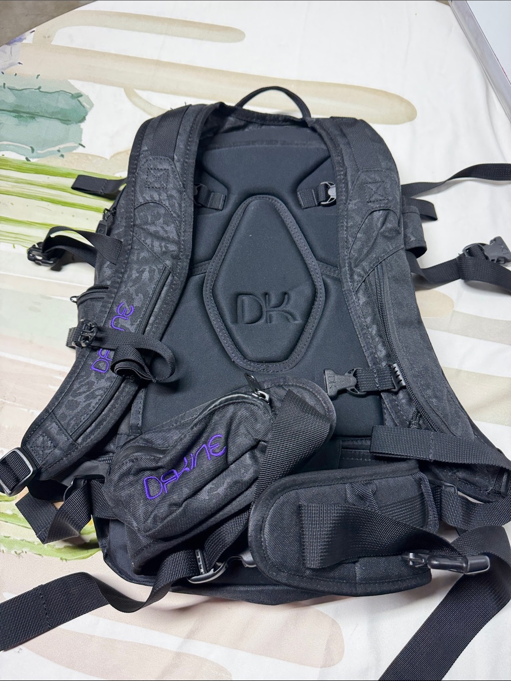 Dakine Heli Pro backpack features a black camouflage pattern and purple brandin - Picture 4 of 6